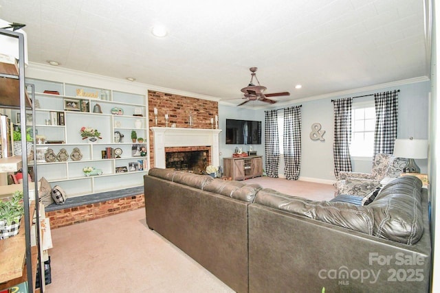 711 Yadkin St, Albemarle, NC 28001 - living area with crown molding, carpet, a ceiling fan, a brick fireplace, and recessed lighting