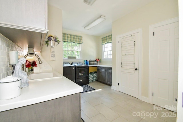 711 Yadkin St, Albemarle, NC 28001 - kitchen featuring washer and clothes dryer, light countertops, backsplash, and light tile patterned floors