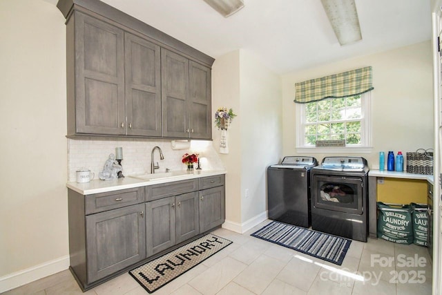 711 Yadkin St, Albemarle, NC 28001 - laundry area with washing machine and clothes dryer, cabinet space, and light tile patterned floors