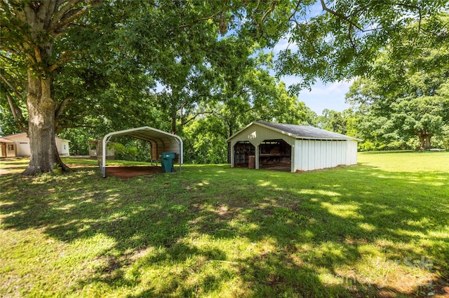 2028 Old Latter Rd, Newton, NC 28658 - view of grassy yard with a detached carport, an outdoor structure, an outbuilding, a garage, and view of wooded area