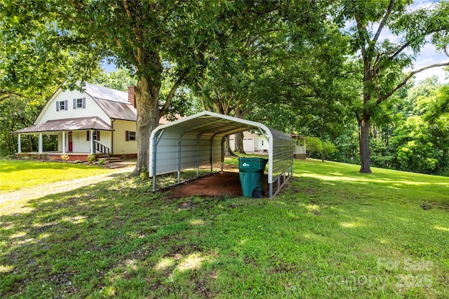 2028 Old Latter Rd, Newton, NC 28658 - view of green lawn with dirt driveway, a detached carport, and covered porch