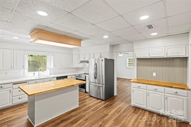 2028 Old Latter Rd, Newton, NC 28658 - kitchen featuring wooden counters, stainless steel appliances, white cabinets, wood finished floors, and under cabinet range hood