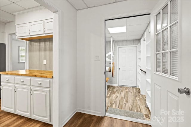 2028 Old Latter Rd, Newton, NC 28658 - kitchen with wood counters, a paneled ceiling, wood finished floors, and white cabinetry