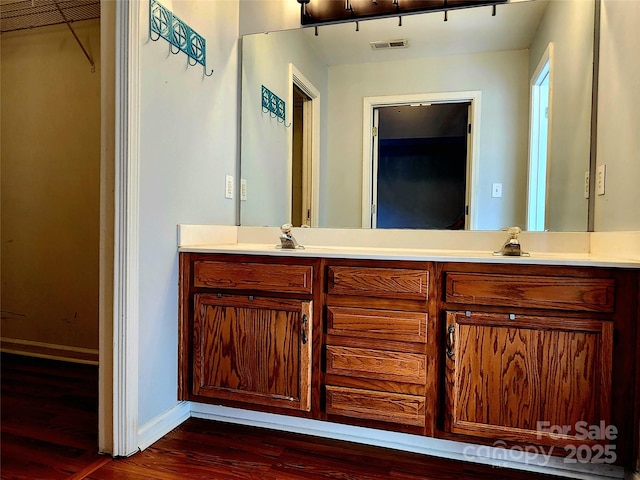 3108 Leicester Dr, Matthews, NC 28104 - bathroom featuring double vanity, wood finished floors, and a walk in closet