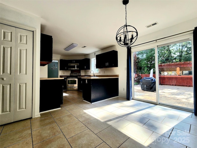 3108 Leicester Dr, Matthews, NC 28104 - kitchen featuring dark cabinetry, freestanding refrigerator, stainless steel electric range oven, a chandelier, and light tile patterned floors