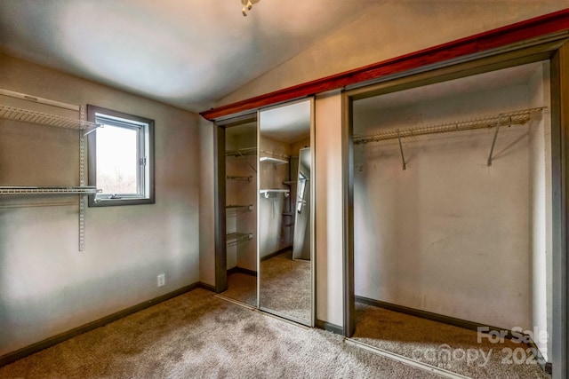 3607 Austin Rd, Monroe, NC 28112 - unfurnished bedroom featuring vaulted ceiling, carpet flooring, and two closets