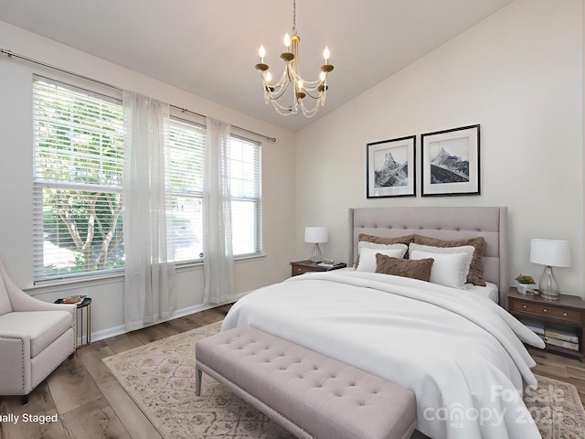 621 Pine Links Dr, Tega Cay, SC 29708 - bedroom with a chandelier, light wood-type flooring, and vaulted ceiling
