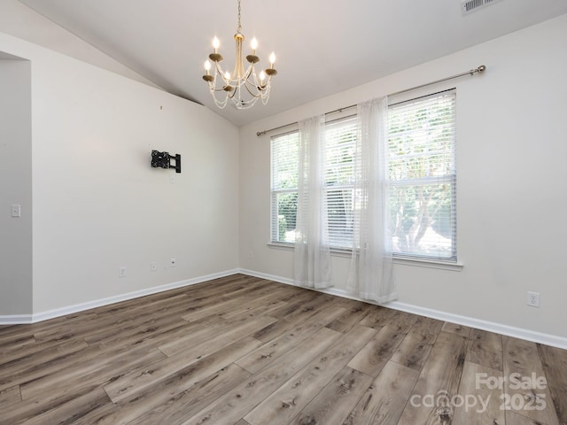 621 Pine Links Dr, Tega Cay, SC 29708 - empty room with a chandelier, wood finished floors, plenty of natural light, and lofted ceiling