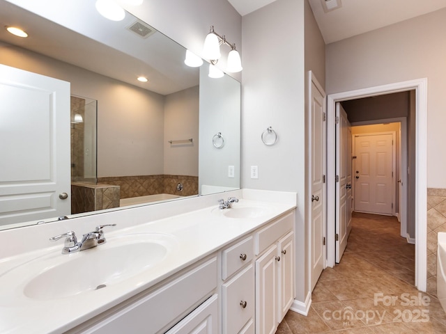 621 Pine Links Dr, Tega Cay, SC 29708 - bathroom with tile patterned floors, a garden tub, double vanity, and recessed lighting