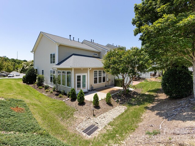 621 Pine Links Dr, Tega Cay, SC 29708 - rear view of property featuring a yard, a patio area, and a shingled roof