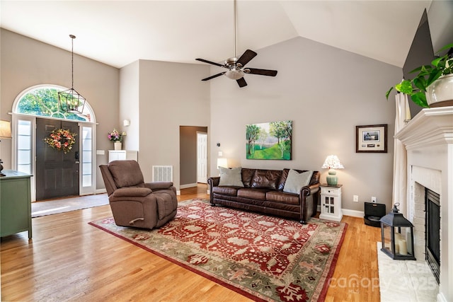 2124 Congress Ct, Kannapolis, NC 28083 - living area featuring high vaulted ceiling, a ceiling fan, wood finished floors, and a brick fireplace