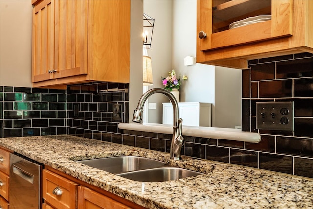 2124 Congress Ct, Kannapolis, NC 28083 - kitchen featuring stainless steel dishwasher, backsplash, light stone countertops, and brown cabinets