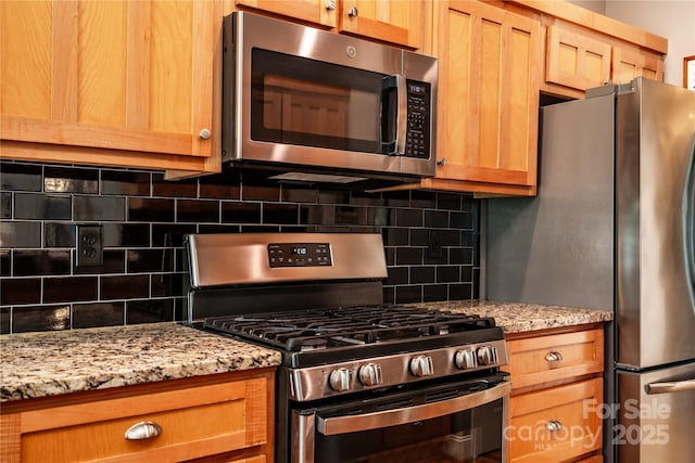 2124 Congress Ct, Kannapolis, NC 28083 - kitchen with appliances with stainless steel finishes, backsplash, and light stone counters