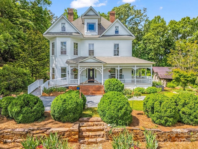 1111 Bills Creek Rd, Lake Lure, NC 28746 - victorian home featuring covered porch, a chimney, and roof with shingles
