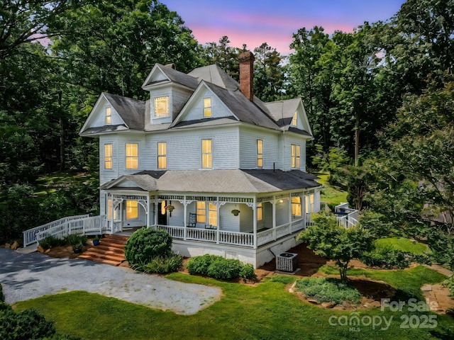 1111 Bills Creek Rd, Lake Lure, NC 28746 - view of front facade featuring covered porch, a chimney, and a front lawn