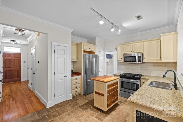3535 Selwyn Farms Ln, Charlotte, NC 28209 - kitchen featuring cream cabinetry, appliances with stainless steel finishes, wood counters, backsplash, and crown molding