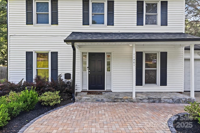 11401 Lone Star Cir, Charlotte, NC 28226 - entrance to property with covered porch, roof with shingles, and a garage