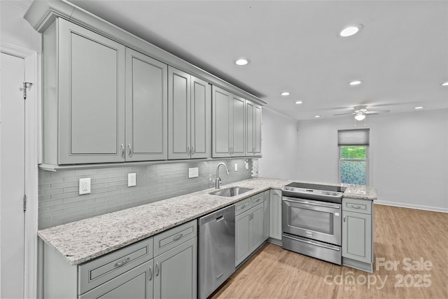 11401 Lone Star Cir, Charlotte, NC 28226 - kitchen with appliances with stainless steel finishes, gray cabinets, light wood-style flooring, backsplash, and a peninsula