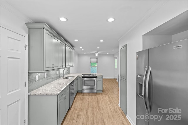 11401 Lone Star Cir, Charlotte, NC 28226 - kitchen featuring stainless steel appliances, gray cabinets, light wood-style floors, a ceiling fan, and ornamental molding