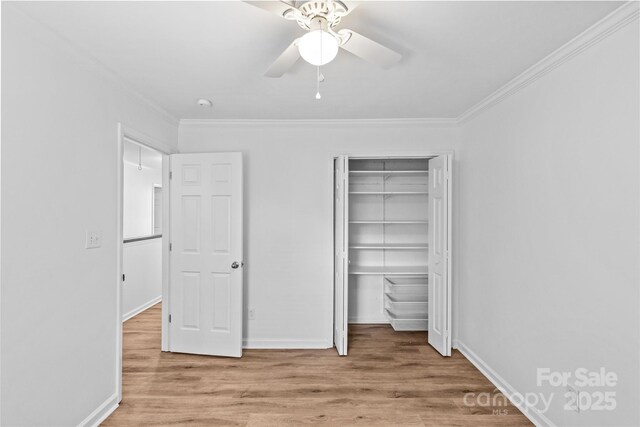 11401 Lone Star Cir, Charlotte, NC 28226 - unfurnished bedroom featuring ornamental molding, wood finished floors, a closet, and a ceiling fan