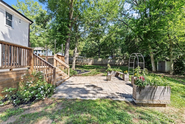 11401 Lone Star Cir, Charlotte, NC 28226 - fenced backyard featuring a storage shed, a patio area, view of wooded area, a deck, and stairway