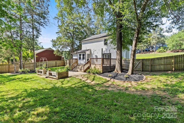 11401 Lone Star Cir, Charlotte, NC 28226 - rear view of house with a vegetable garden, a wooden deck, and a fenced backyard