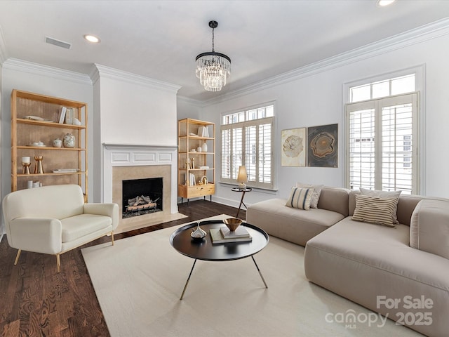 344 S Laurel Ave, Charlotte, NC 28207 - living room featuring wood finished floors, ornamental molding, a fireplace, plenty of natural light, and a chandelier