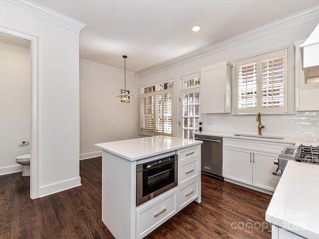 344 S Laurel Ave, Charlotte, NC 28207 - kitchen featuring appliances with stainless steel finishes, light countertops, crown molding, tasteful backsplash, and dark wood-style floors