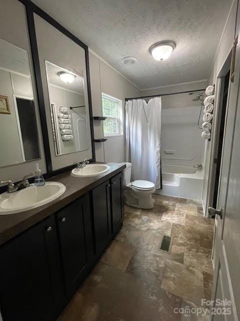 25 Mountain View Rdg, Fairview, NC 28730 - full bathroom featuring crown molding, double vanity, shower / bath combo, stone finish flooring, and a textured ceiling