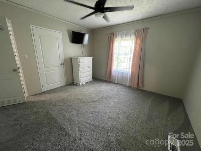 25 Mountain View Rdg, Fairview, NC 28730 - unfurnished bedroom featuring ornamental molding, carpet floors, and a ceiling fan