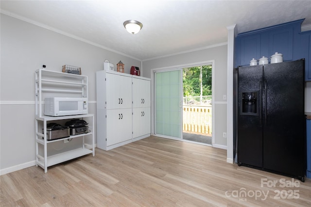 25 Mountain View Rdg, Fairview, NC 28730 - kitchen with black fridge with ice dispenser, white microwave, light wood-style flooring, ornamental molding, and blue cabinets