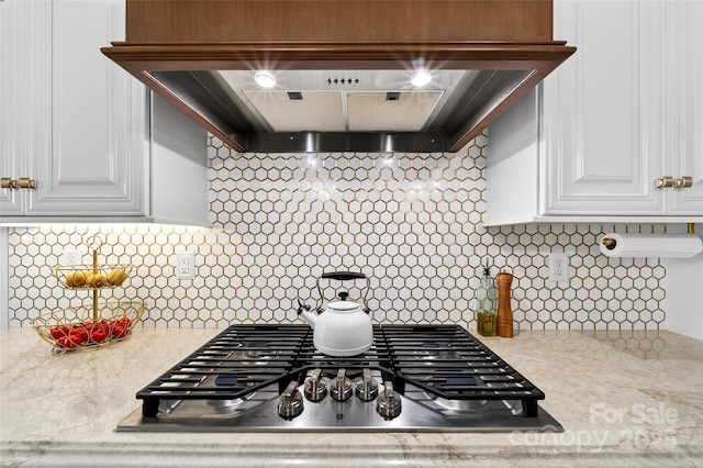 3981 Spinnaker Pl, Denver, NC 28037 - kitchen featuring stainless steel gas stovetop, under cabinet range hood, light countertops, and white cabinets