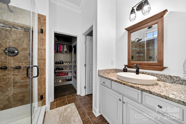 3981 Spinnaker Pl, Denver, NC 28037 - bathroom featuring ornamental molding, vanity, a walk in closet, a shower stall, and tile patterned flooring