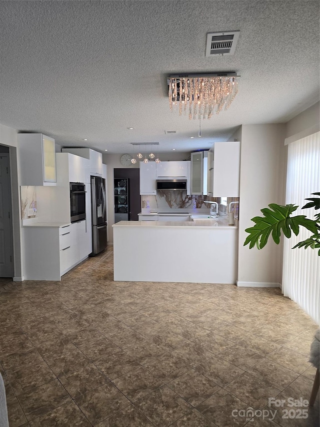 3 Hidden Sands Ct, Columbia, SC 29229 - kitchen featuring black oven, stainless steel refrigerator with ice dispenser, exhaust hood, white cabinets, and light countertops