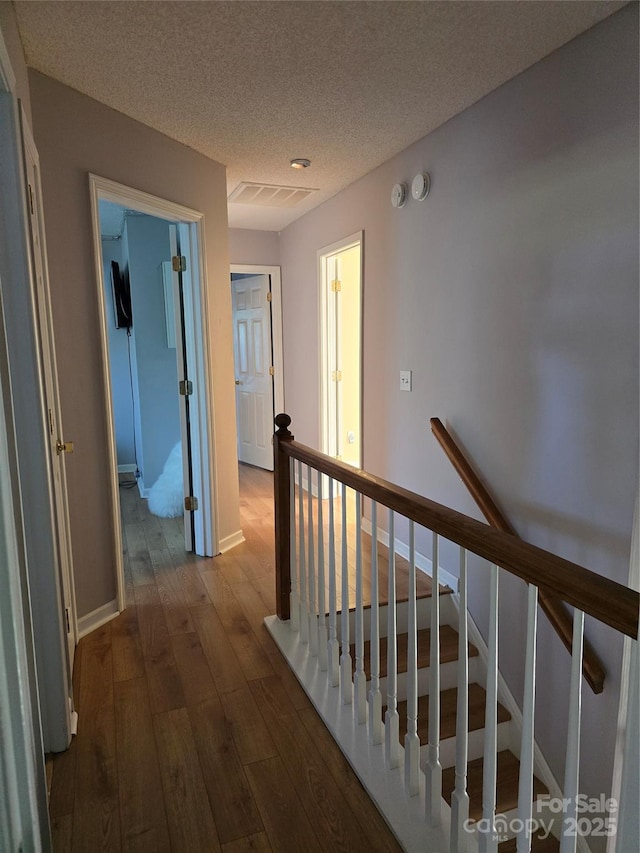 3 Hidden Sands Ct, Columbia, SC 29229 - corridor with an upstairs landing, dark wood-style flooring, and a textured ceiling