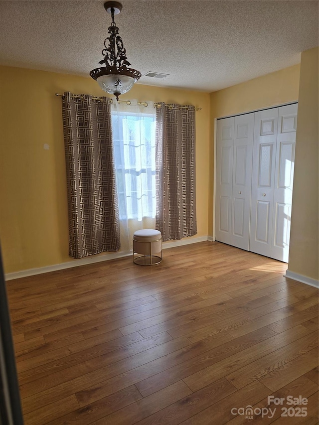 3 Hidden Sands Ct, Columbia, SC 29229 - unfurnished dining area with hardwood / wood-style floors, a textured ceiling, and a chandelier