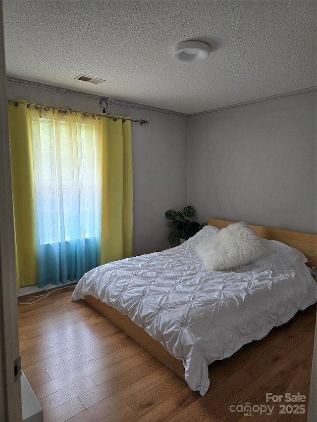 3 Hidden Sands Ct, Columbia, SC 29229 - bedroom with a textured ceiling and wood-type flooring