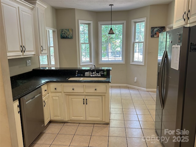 207 Wagon Ln, Rutherfordton, NC 28139 - kitchen with appliances with stainless steel finishes, a peninsula, light tile patterned floors, and decorative light fixtures