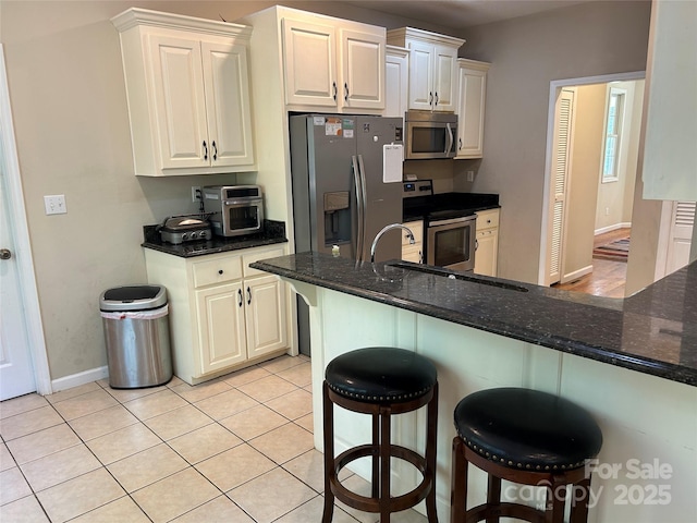 207 Wagon Ln, Rutherfordton, NC 28139 - kitchen featuring stainless steel appliances, a breakfast bar, and dark stone countertops