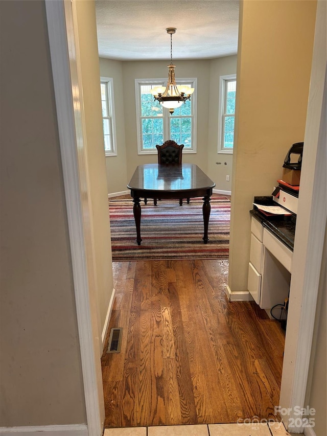 207 Wagon Ln, Rutherfordton, NC 28139 - hall featuring dark wood-style flooring and a chandelier