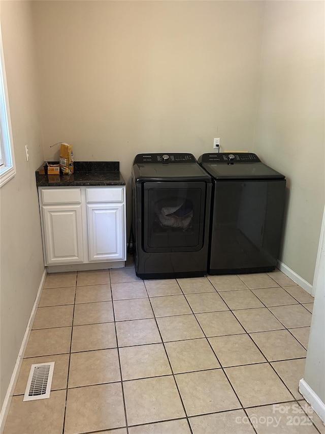 207 Wagon Ln, Rutherfordton, NC 28139 - laundry room with washer and dryer, cabinet space, and light tile patterned floors