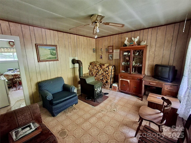2087 Henry Rd, Sylva, NC 28779 - living area featuring a wood stove, a ceiling fan, and wood walls