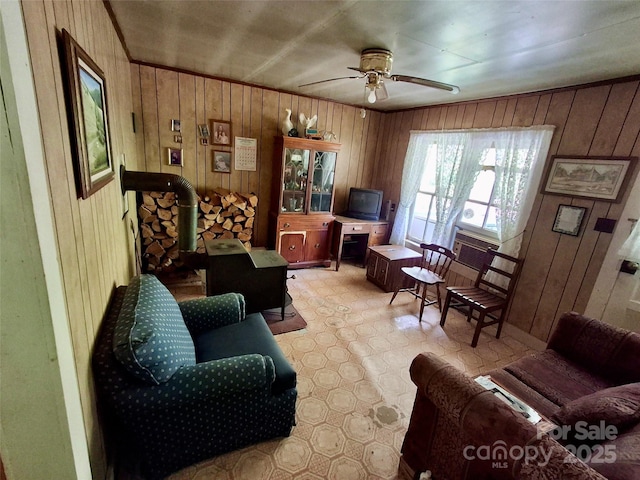 2087 Henry Rd, Sylva, NC 28779 - living room with a wood stove, wood walls, and ceiling fan