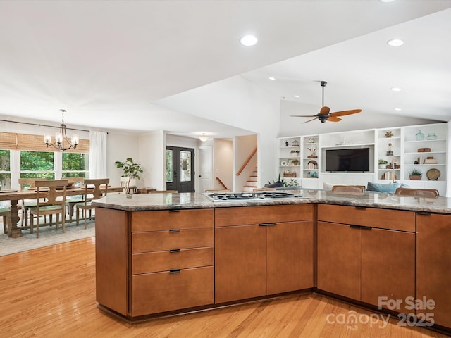 1711 Apple Tree Ln Unit 28, Fort Mill, SC 29715 - kitchen with vaulted ceiling, open floor plan, gas stovetop, light wood-type flooring, and light stone counters