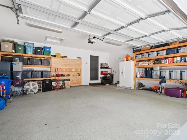 1711 Apple Tree Ln Unit 28, Fort Mill, SC 29715 - garage with white refrigerator with ice dispenser and a garage door opener