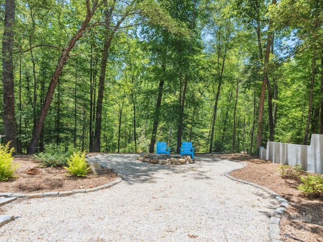 1711 Apple Tree Ln Unit 28, Fort Mill, SC 29715 - view of dirt / gravel road featuring a forest view and curbs