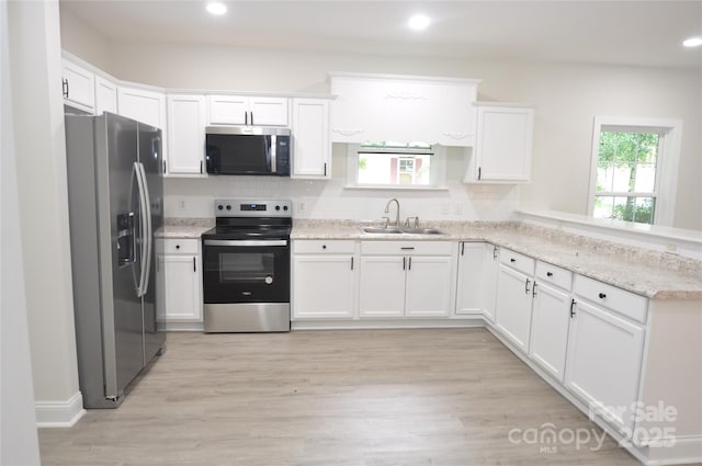 533 Third St Unit 27, Chester, SC 29706 - kitchen with appliances with stainless steel finishes, white cabinets, a peninsula, and recessed lighting
