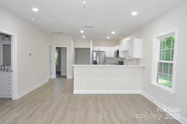533 Third St Unit 27, Chester, SC 29706 - kitchen with stainless steel appliances, a peninsula, light countertops, light wood finished floors, and recessed lighting