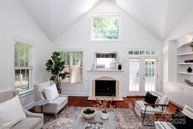 7554 Bluestar Ln, Charlotte, NC 28226 - living area with a high end fireplace, wood finished floors, high vaulted ceiling, and french doors