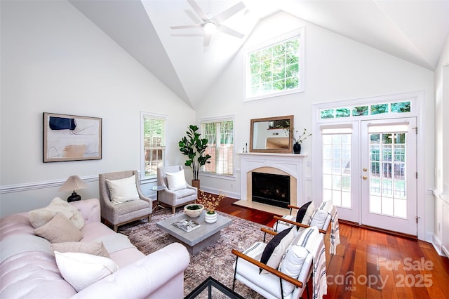 7554 Bluestar Ln, Charlotte, NC 28226 - living area with high vaulted ceiling, healthy amount of natural light, wood finished floors, and a fireplace